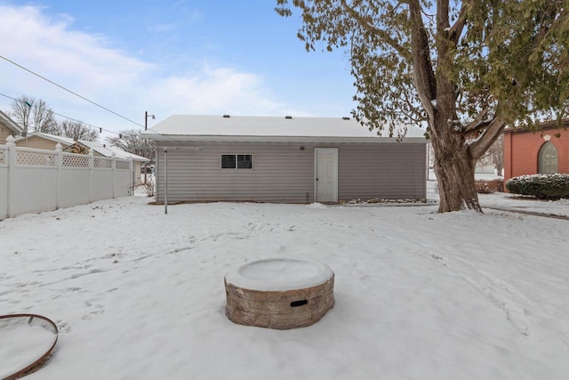 snow covered house featuring an outdoor fire pit