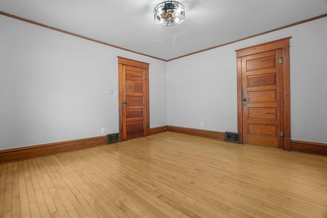 unfurnished room with crown molding and light wood-type flooring