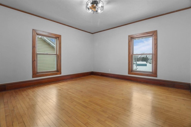 spare room with crown molding and light hardwood / wood-style flooring