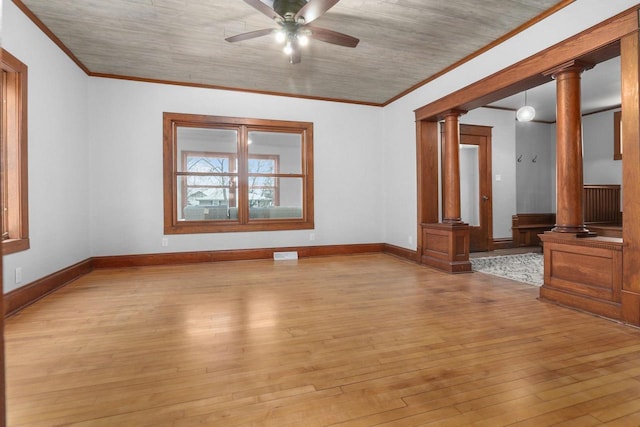 empty room featuring ornate columns, crown molding, ceiling fan, and light hardwood / wood-style floors