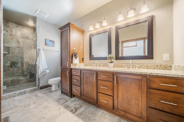 bathroom featuring vanity, an enclosed shower, and toilet