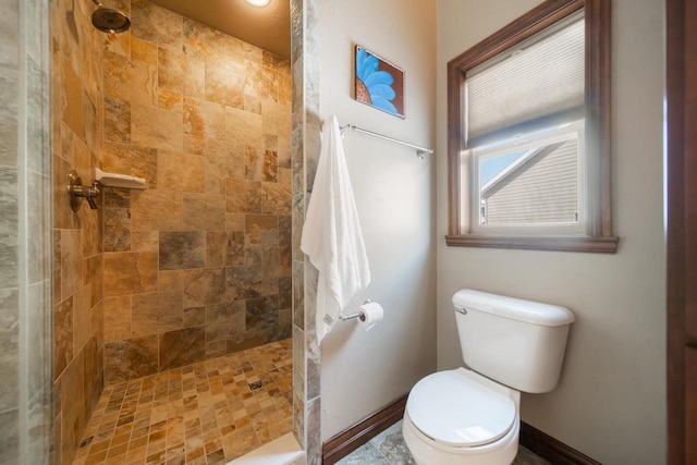 bathroom with tiled shower and toilet