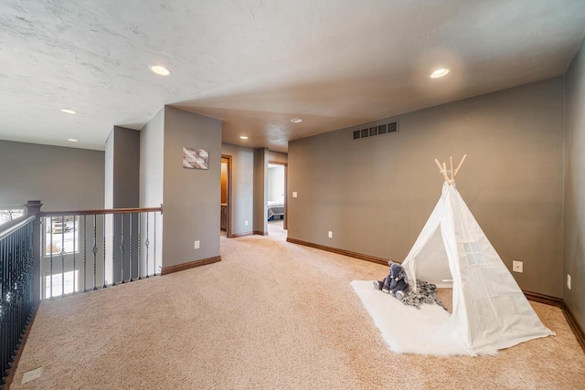 rec room with light colored carpet