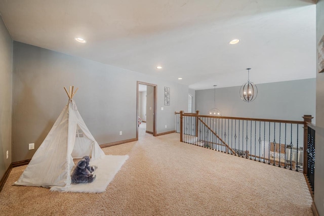 game room featuring an inviting chandelier and light colored carpet