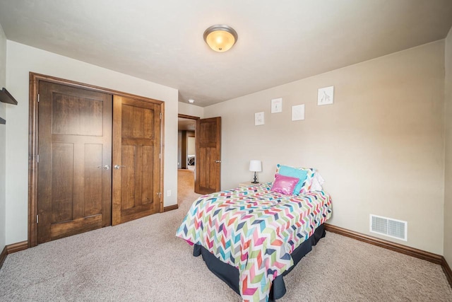 carpeted bedroom with a closet