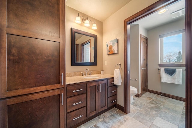 bathroom featuring vanity and toilet