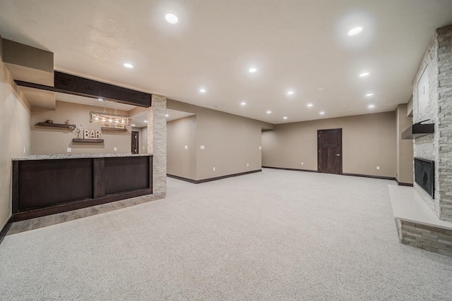 unfurnished living room featuring light carpet and a fireplace