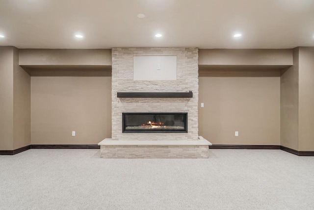 unfurnished living room featuring light colored carpet and a fireplace