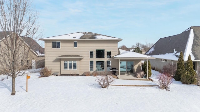 view of snow covered rear of property