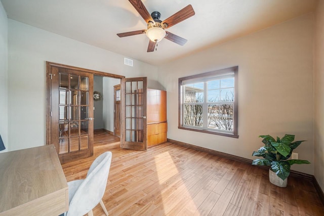 office space featuring hardwood / wood-style flooring, french doors, and ceiling fan