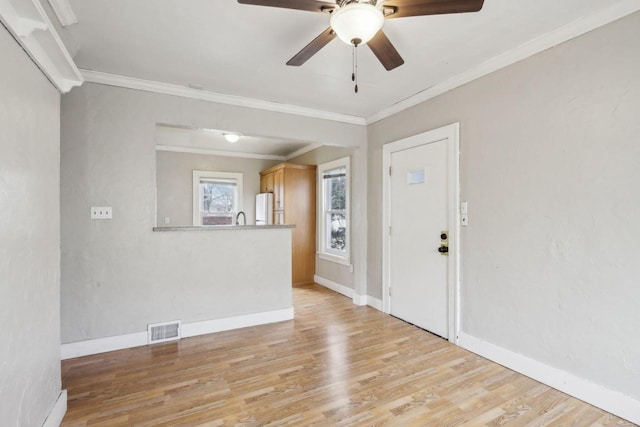 spare room with ornamental molding, sink, ceiling fan, and light hardwood / wood-style floors