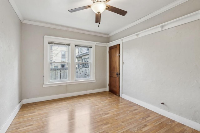 empty room with crown molding, ceiling fan, and light hardwood / wood-style floors