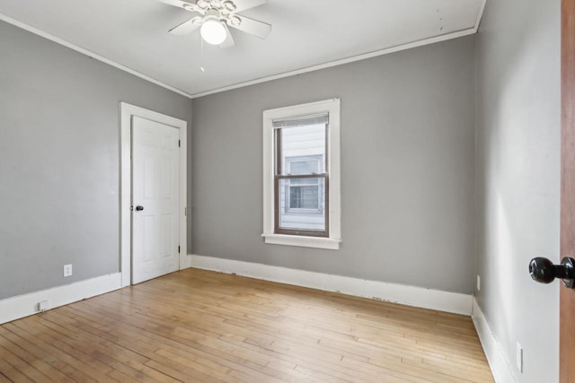 spare room with crown molding, ceiling fan, and light hardwood / wood-style floors