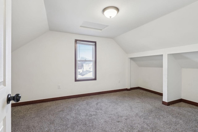 bonus room with lofted ceiling and carpet floors