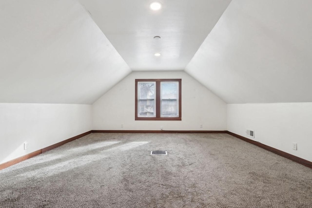 bonus room featuring lofted ceiling and carpet flooring