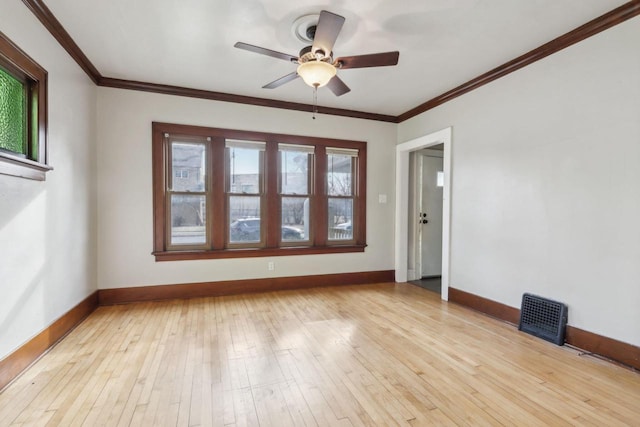 spare room featuring crown molding, light hardwood / wood-style flooring, and ceiling fan