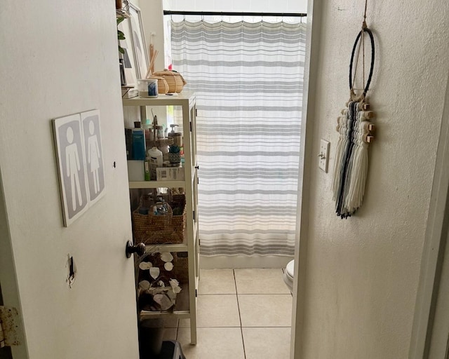 interior space with shower / tub combo, toilet, and tile patterned flooring