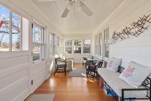 sunroom / solarium with wooden ceiling and ceiling fan