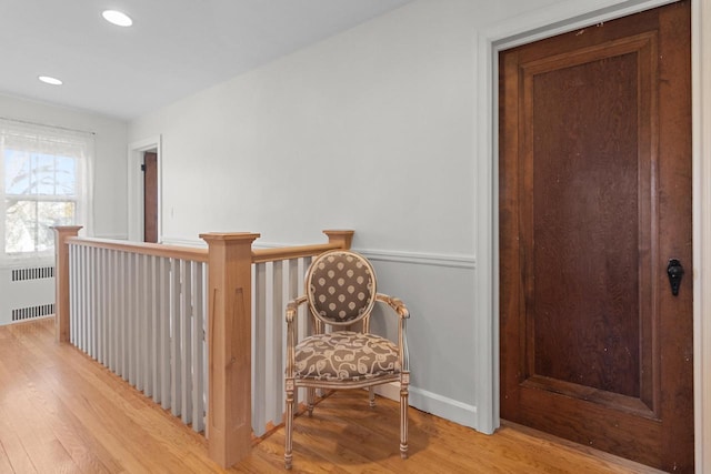 hallway featuring radiator and light hardwood / wood-style floors