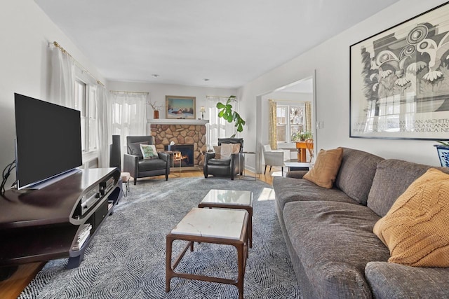 living room with a stone fireplace