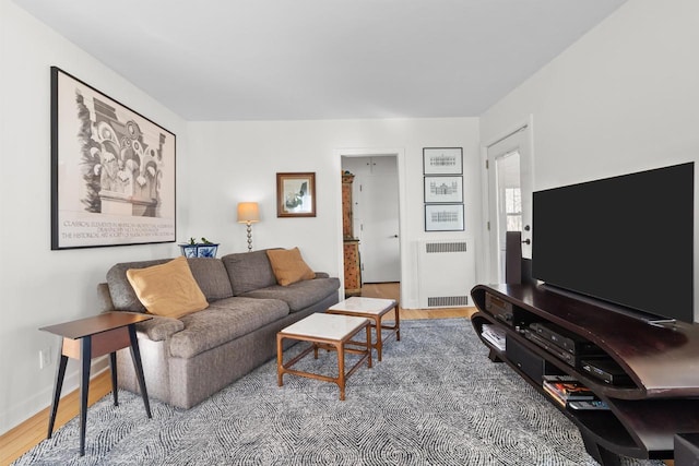 living room featuring hardwood / wood-style flooring and radiator heating unit