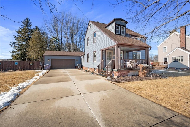 view of front facade featuring an outbuilding, a porch, and a garage