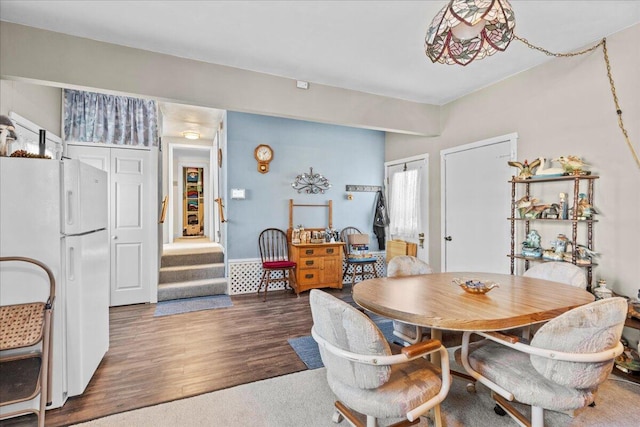 dining area with dark wood-type flooring