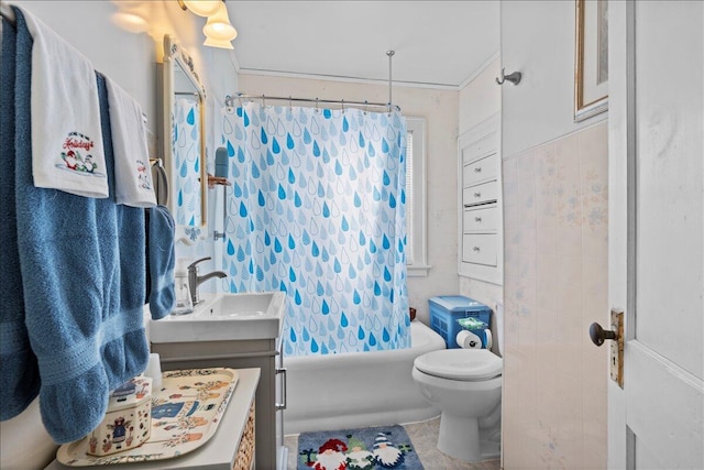 full bathroom with shower / tub combo with curtain, vanity, toilet, and tile walls