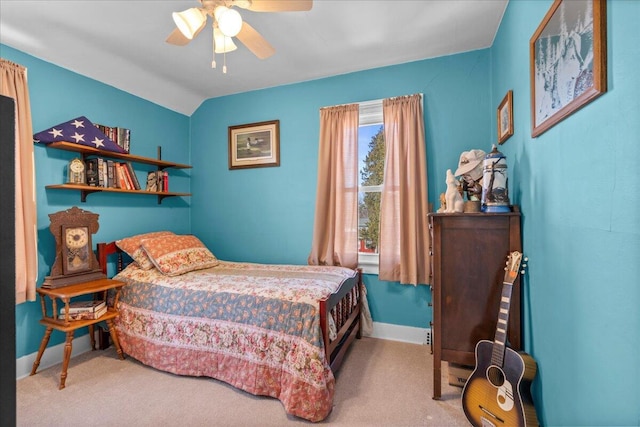 carpeted bedroom with vaulted ceiling and ceiling fan