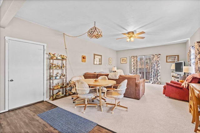 dining area with hardwood / wood-style floors and ceiling fan