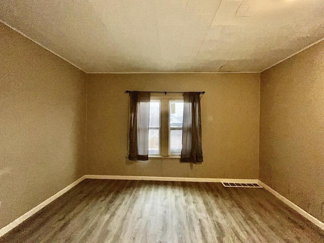 spare room with wood-type flooring