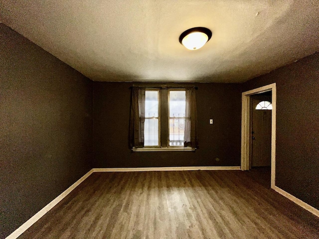 spare room with hardwood / wood-style floors and a textured ceiling