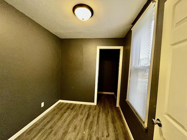 spare room with dark wood-type flooring