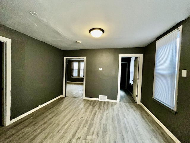 unfurnished bedroom with wood-type flooring