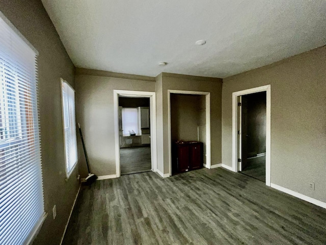 unfurnished bedroom with dark hardwood / wood-style flooring