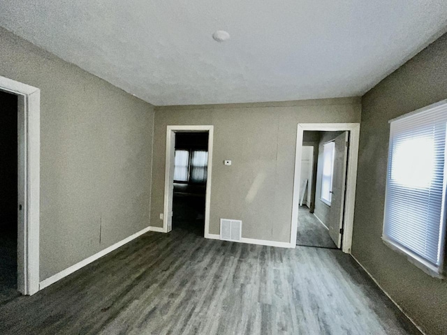 unfurnished bedroom with dark hardwood / wood-style floors