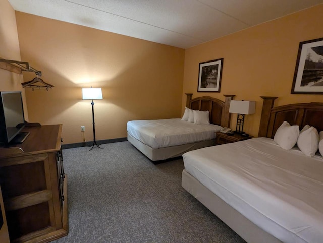 bedroom featuring dark carpet