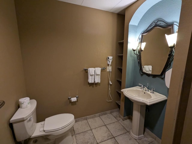 bathroom featuring sink, tile patterned floors, and toilet