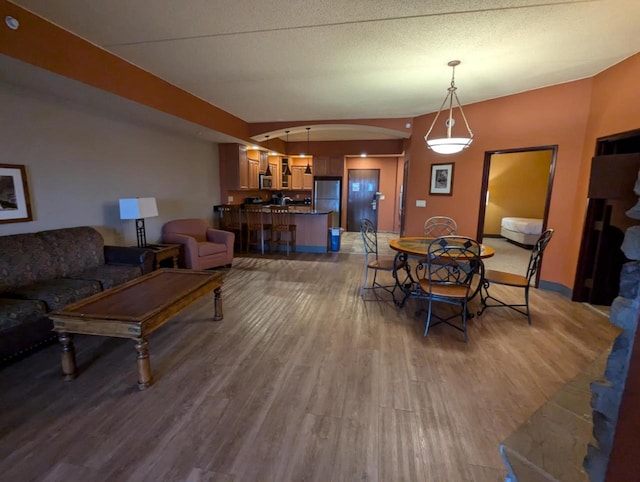 dining room featuring hardwood / wood-style floors and a textured ceiling