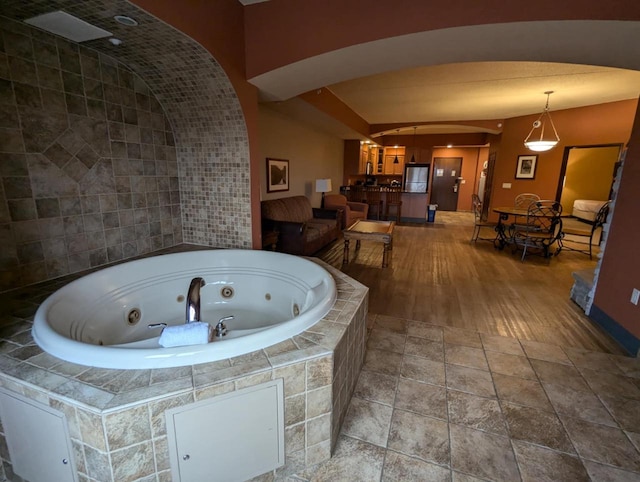 bathroom featuring a relaxing tiled tub