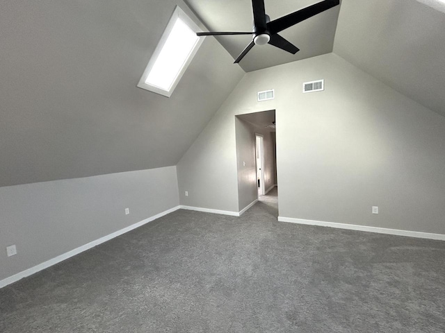 additional living space with lofted ceiling, ceiling fan, and dark colored carpet