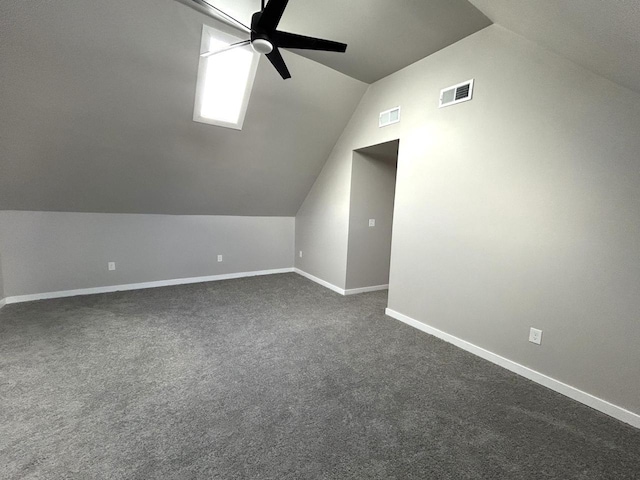 additional living space featuring ceiling fan, lofted ceiling, and dark carpet