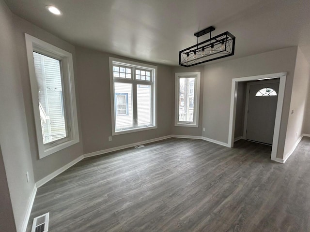 unfurnished dining area featuring wood-type flooring