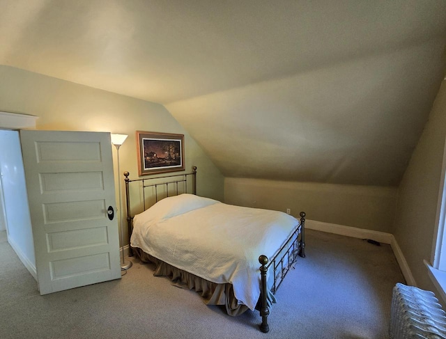 bedroom featuring lofted ceiling and carpet floors