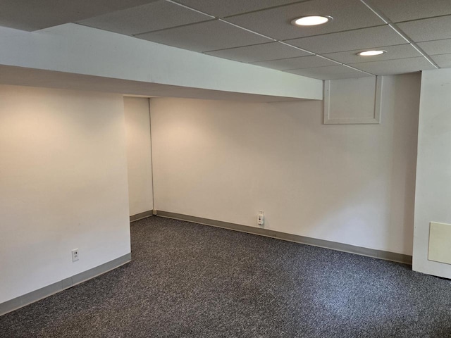 basement with a paneled ceiling