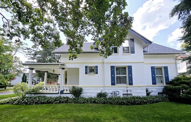 view of front of house with a porch and a front yard