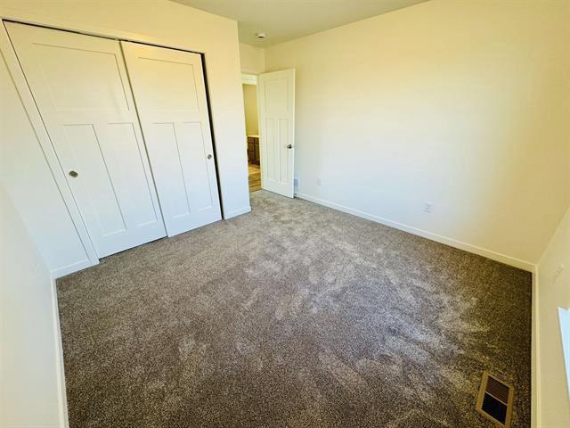 unfurnished bedroom featuring carpet floors and a closet