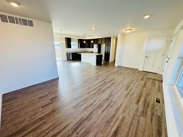 unfurnished living room featuring dark wood-type flooring