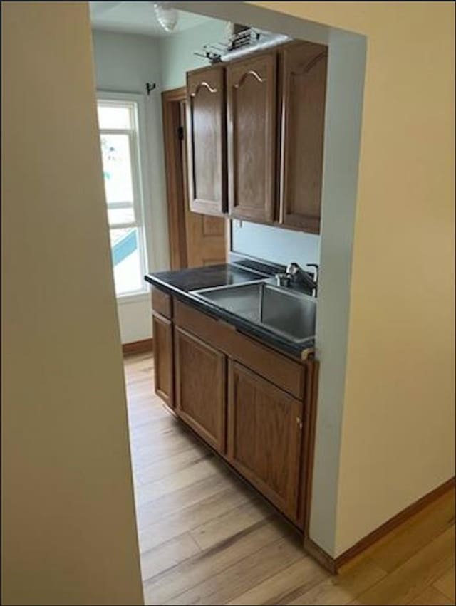 kitchen with sink and light wood-type flooring