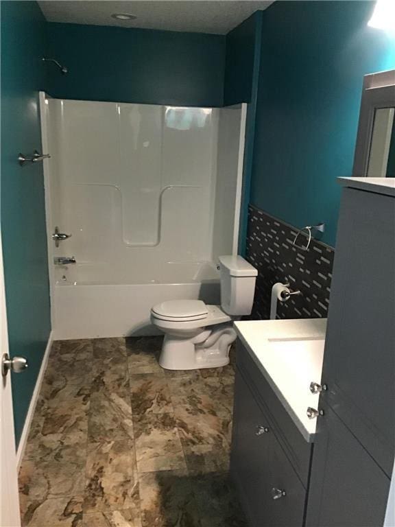 full bathroom with vanity, bathing tub / shower combination, and toilet